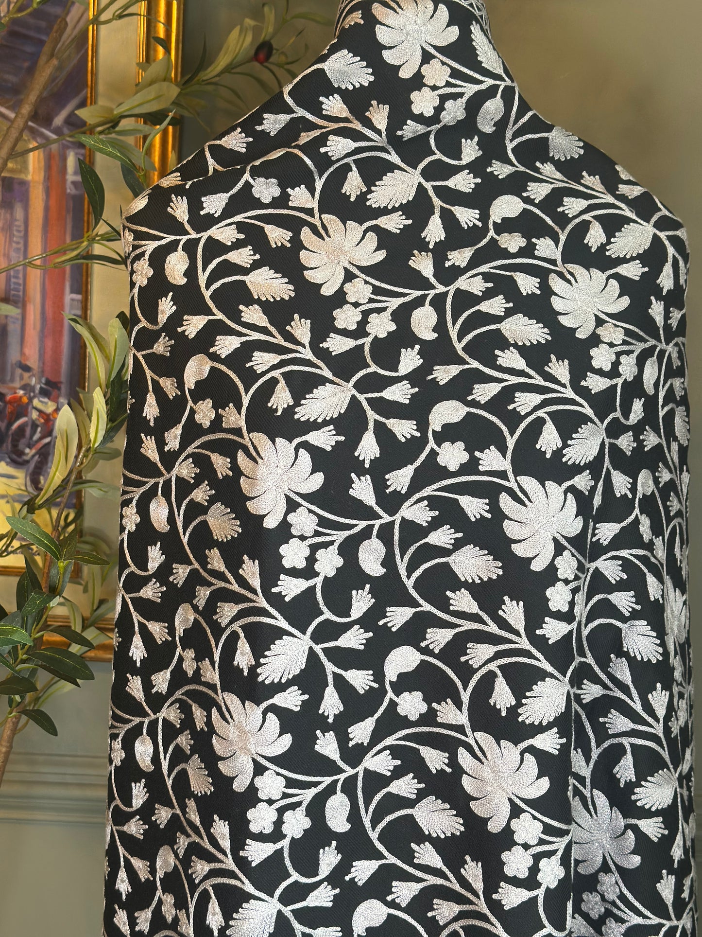 Black fabric with white floral pattern draped over a chair