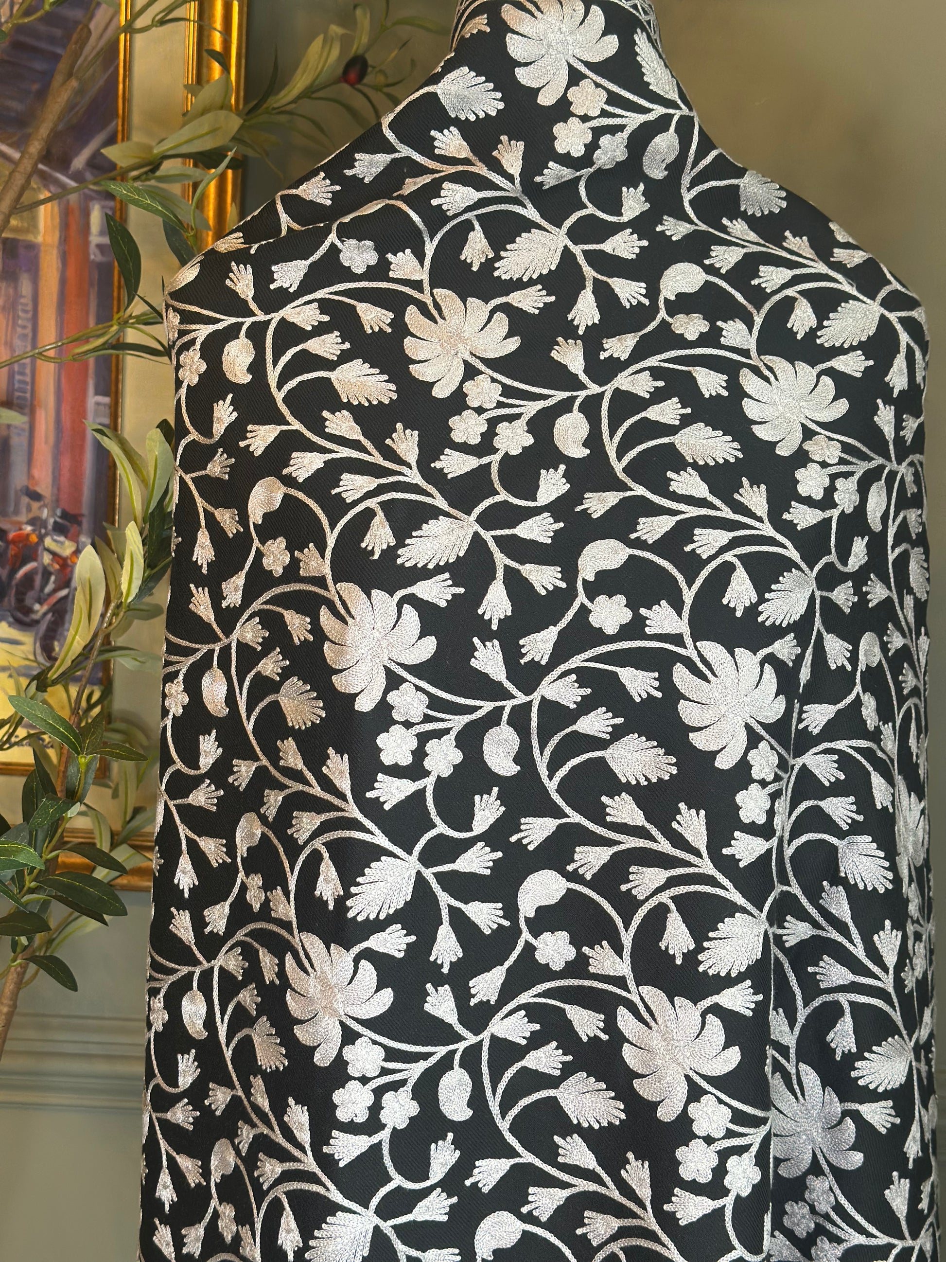 Black fabric with white floral pattern draped over a chair