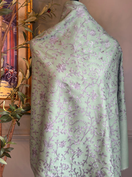 Light green floral patterned dress on a mannequin against a neutral background