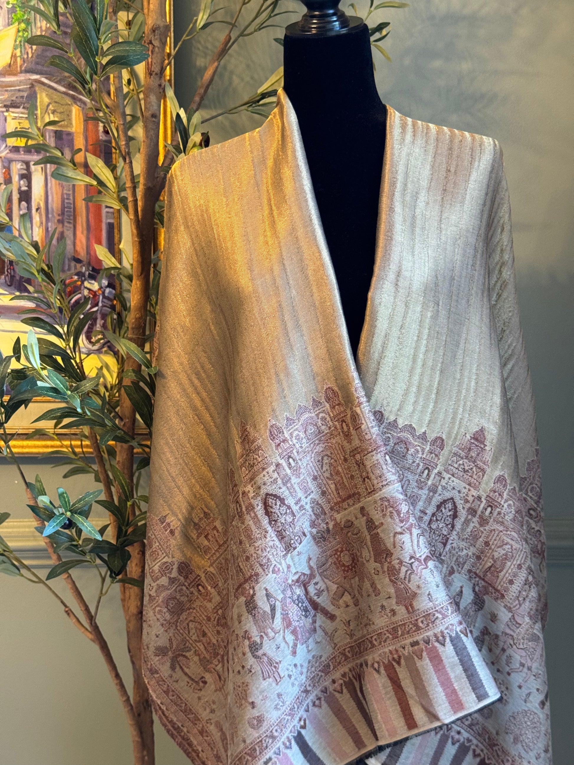 Textured scarf with pattern draped over a mannequin against a neutral background