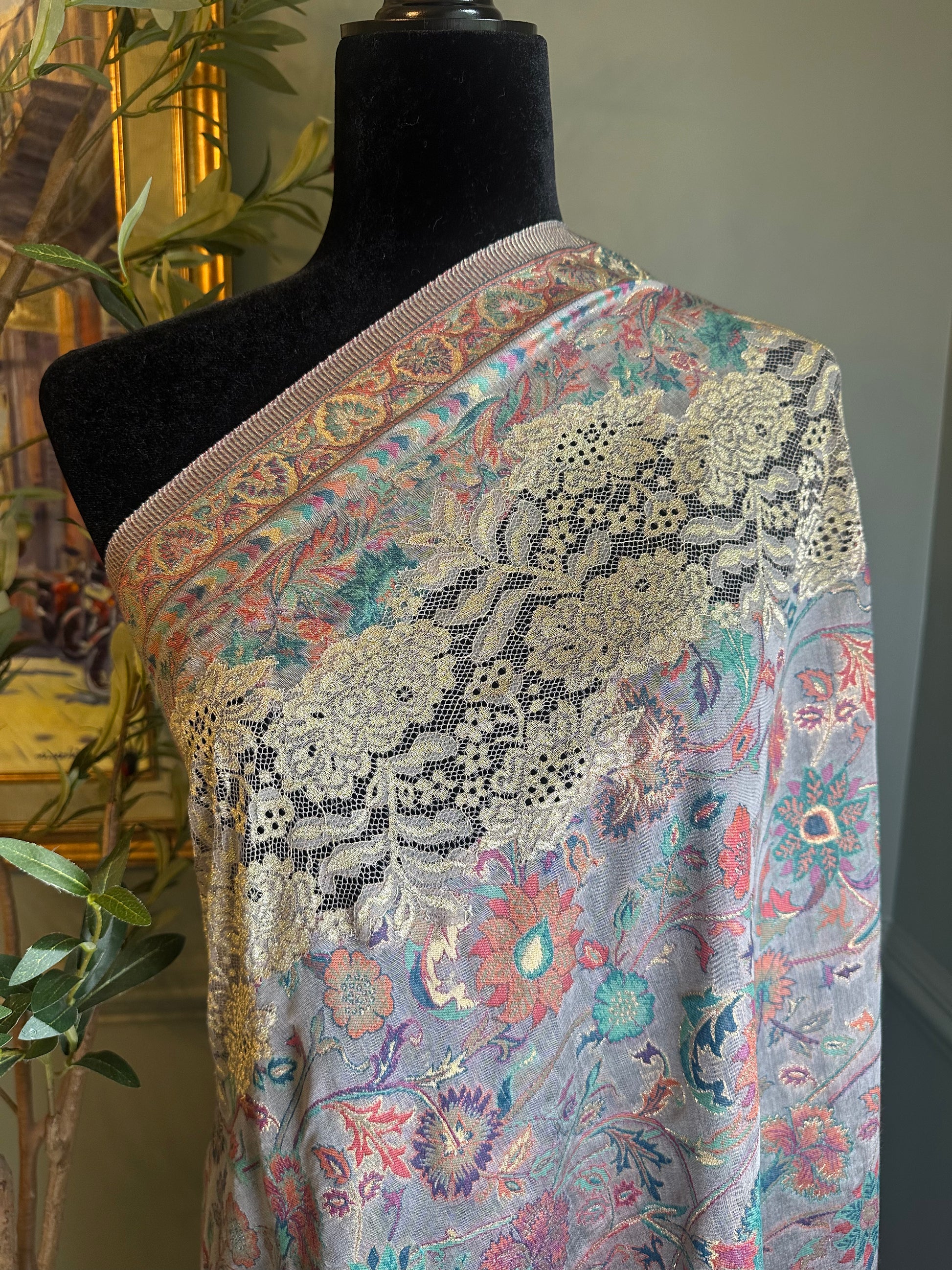 Floral patterned fabric draped over a mannequin with an indoor background