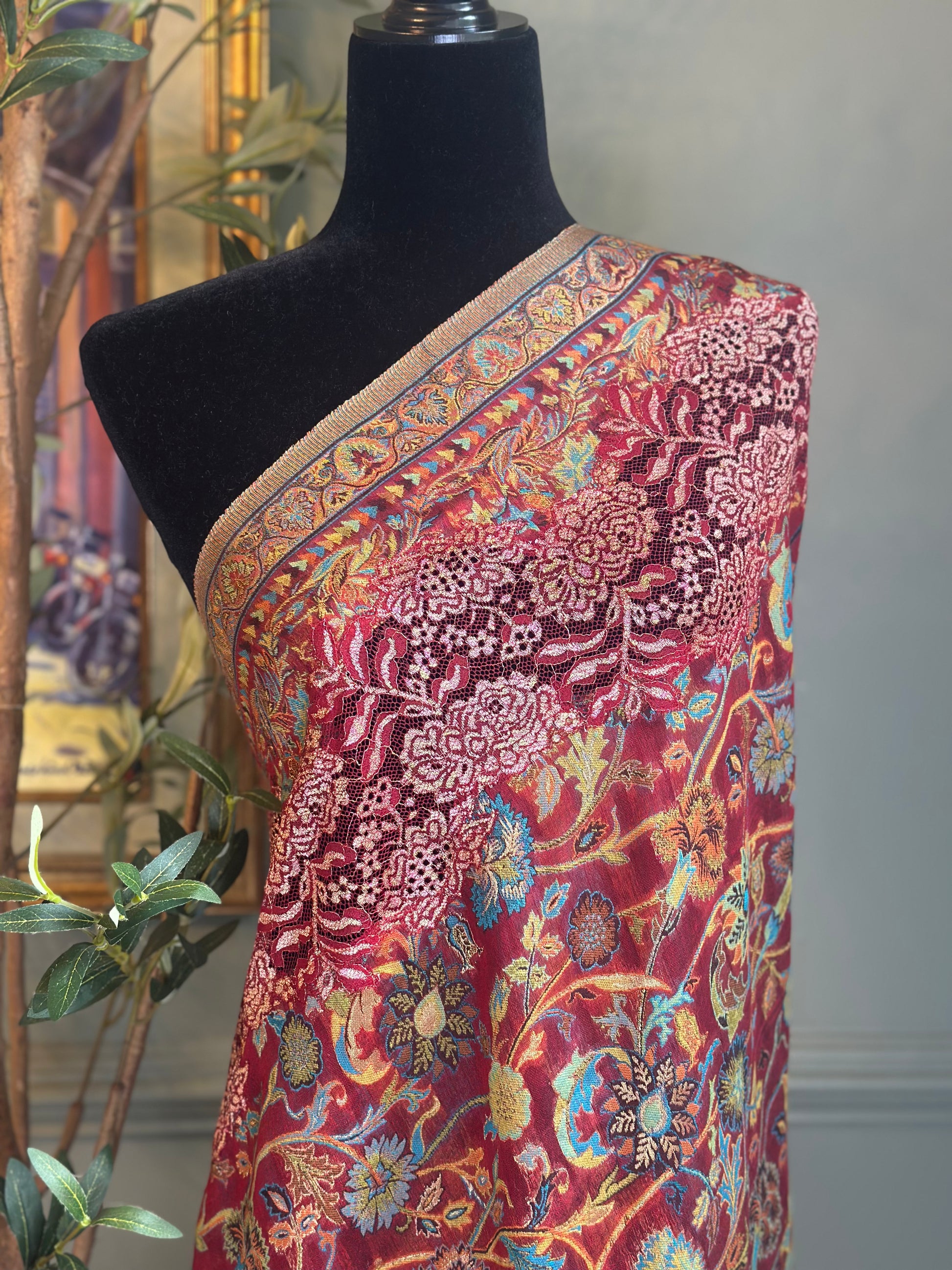 Colorful patterned fabric on a mannequin against a neutral background