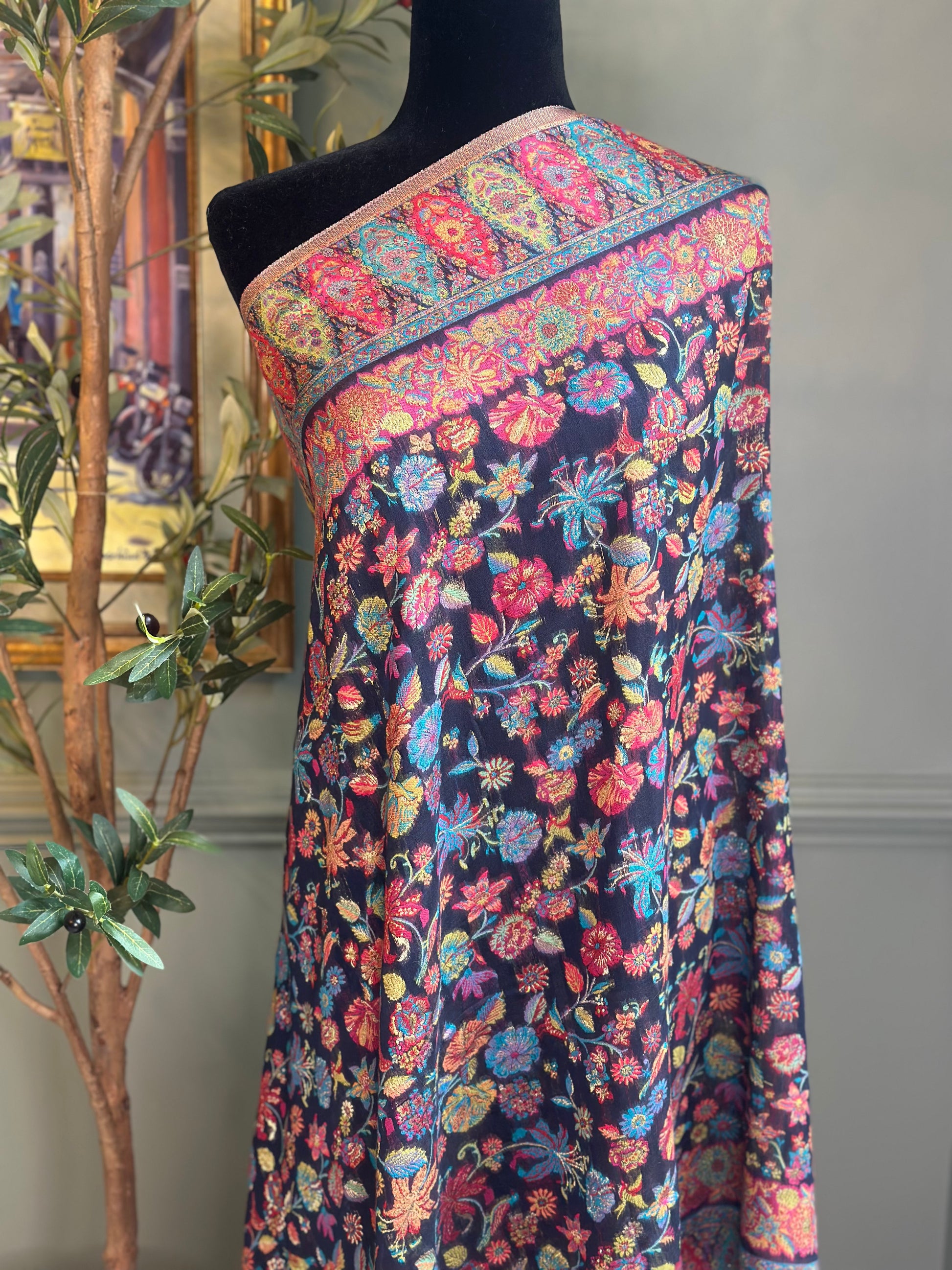 Colorful floral patterned fabric on a mannequin against a neutral background