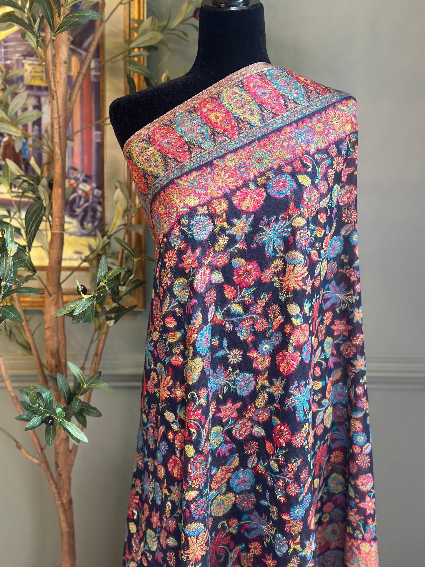Colorful floral patterned fabric on a mannequin against a neutral background