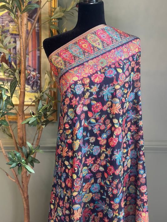 Colorful floral patterned fabric on a mannequin against a neutral background