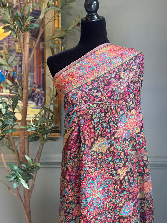 Colorful floral patterned wrap on a mannequin against a neutral background
